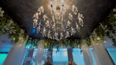 Tracking-wide-shot-of-a-chandelier,-luxurious-restaurant,-interior