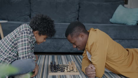 father and son playing chess together