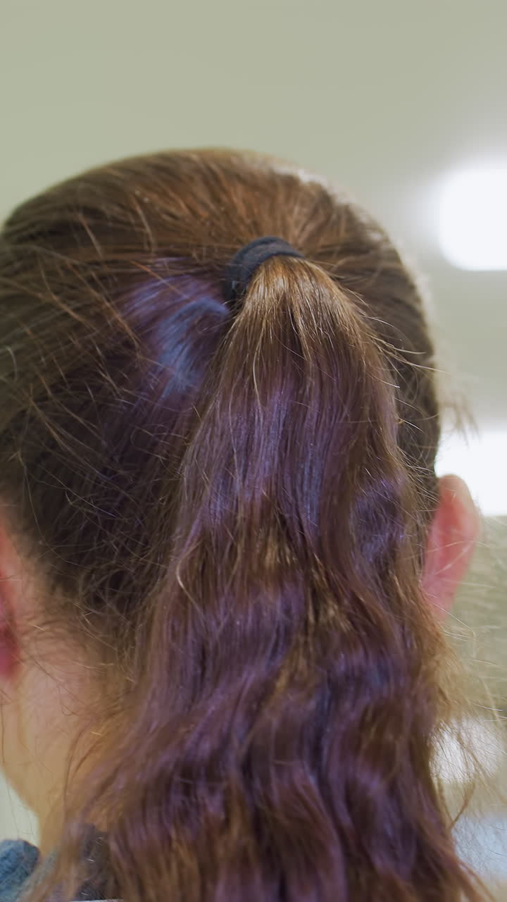 Textured wavy hair awaiting appointment, Clinic scene with woman showing textured wavy hairstyle, Patient with styled wavy hair waiting quietly in clinical setting under gentle lighting
