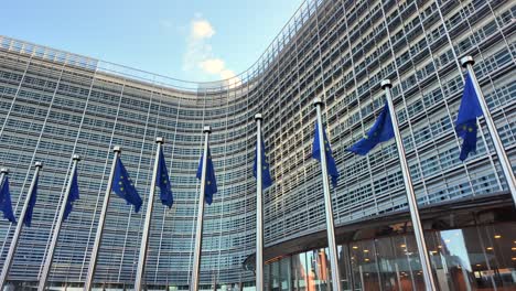 eu flags waving in front of berlaymont commission headquarters
