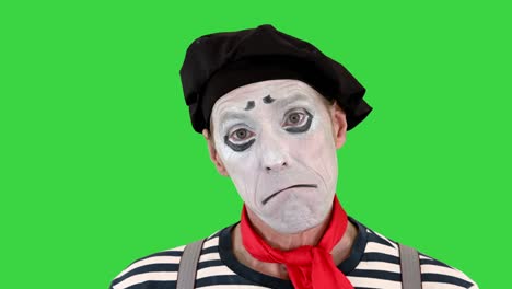 sad mime looking to camera on a green screen, chroma key