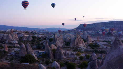 Dolly-En-Tiro-De-Globos-Aerostáticos-Volando-Sobre-Las-Chimeneas-De-Hadas-En-Goreme-Cappadoica,-Estambul,-Turquía