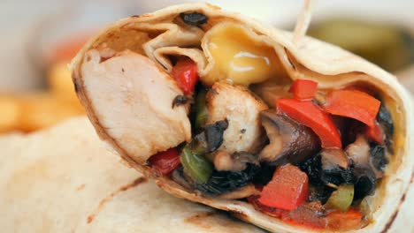 close-up of a chicken and vegetable wrap