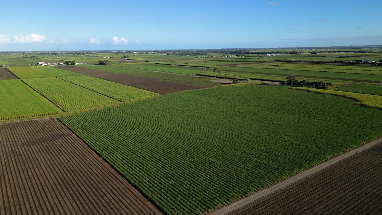 Left to right aerial views over sugar cane farms and prawn farms in South East Queensland, Australia