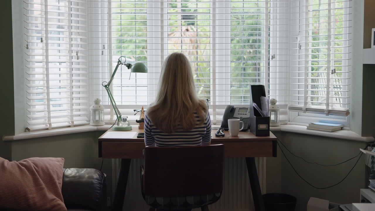 Woman working at desk in home office