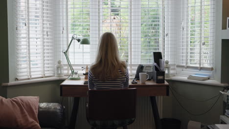 woman working at desk in home office