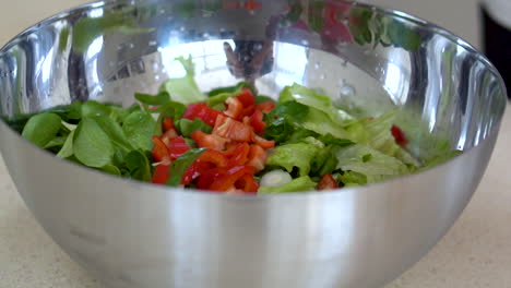 making a fresh salad with red bell pepper and lettuce