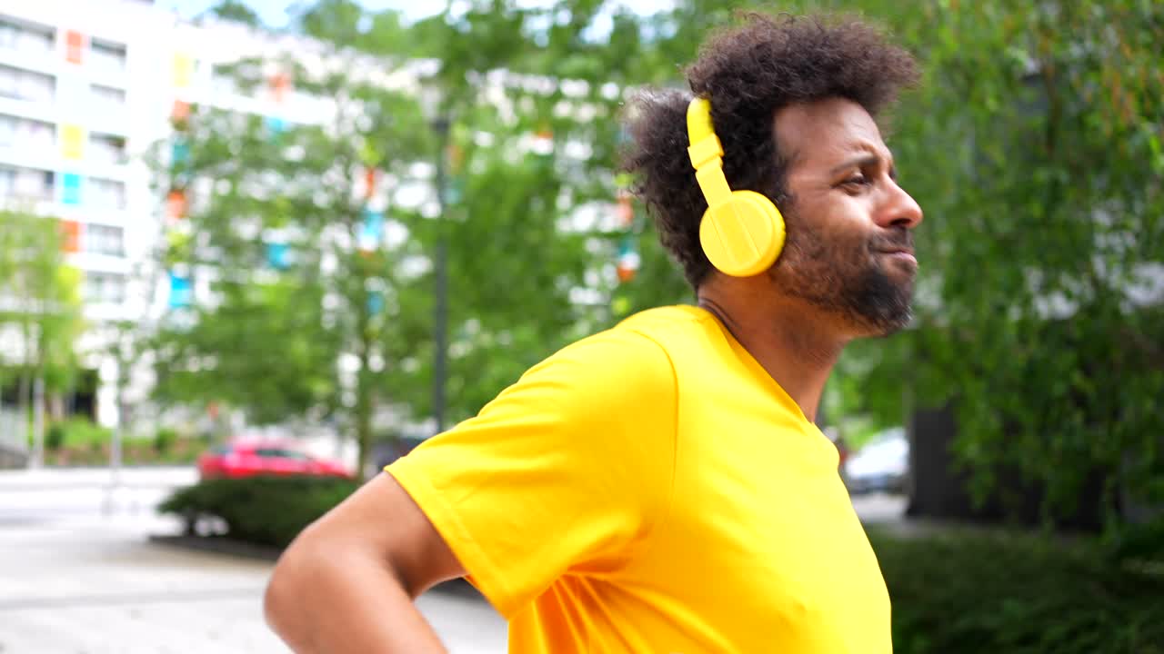 Man walking down the street listening to music with headphones