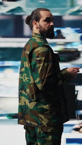 vertical video armed forces officer monitoring drone and satellite imagery for intelligence