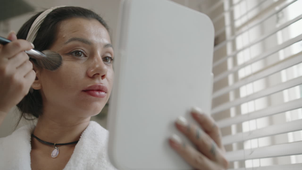 Caucasian Girl Applying Foundation on Face with Brush