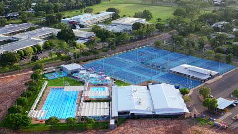 aerial drone of recreational swimming pool and tennis courts at golden hour in moulden northern territory australia