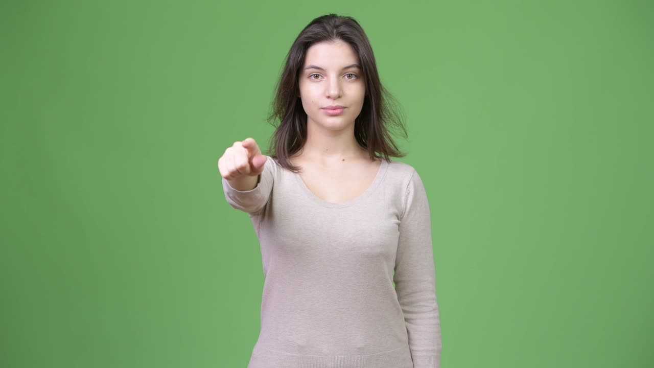 Young beautiful woman pointing to camera