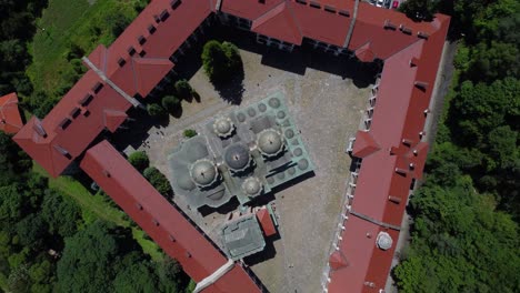drone ascending above and looking down onto rila monastery, bulgaria