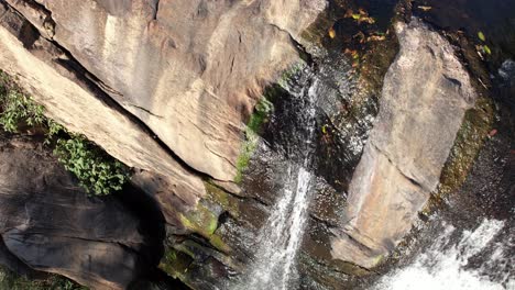 camera capturing the waterfall from top down highlighting the flow and plunge pool