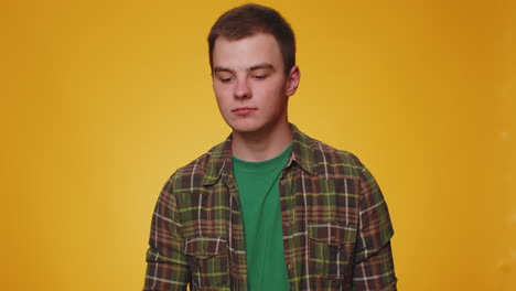 young man looking approvingly, showing ok approve feedback gesture like sign positive something good