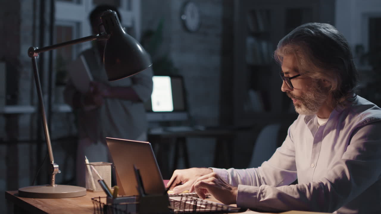 Professional working on laptop late in the office