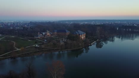 Flying-towards-the-palace-of-Brancoveanu-in-Mogosoaia-park,-by-the-lake,-Bucharest,-Romania