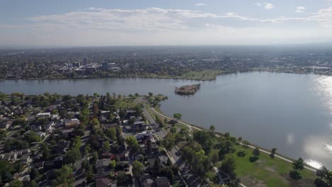 a 4k high-flying drone shot of sloan’s lake, the biggest lake in the city of denver, colorado, and home to the second largest park in the city, and a myriad of outdoor activities