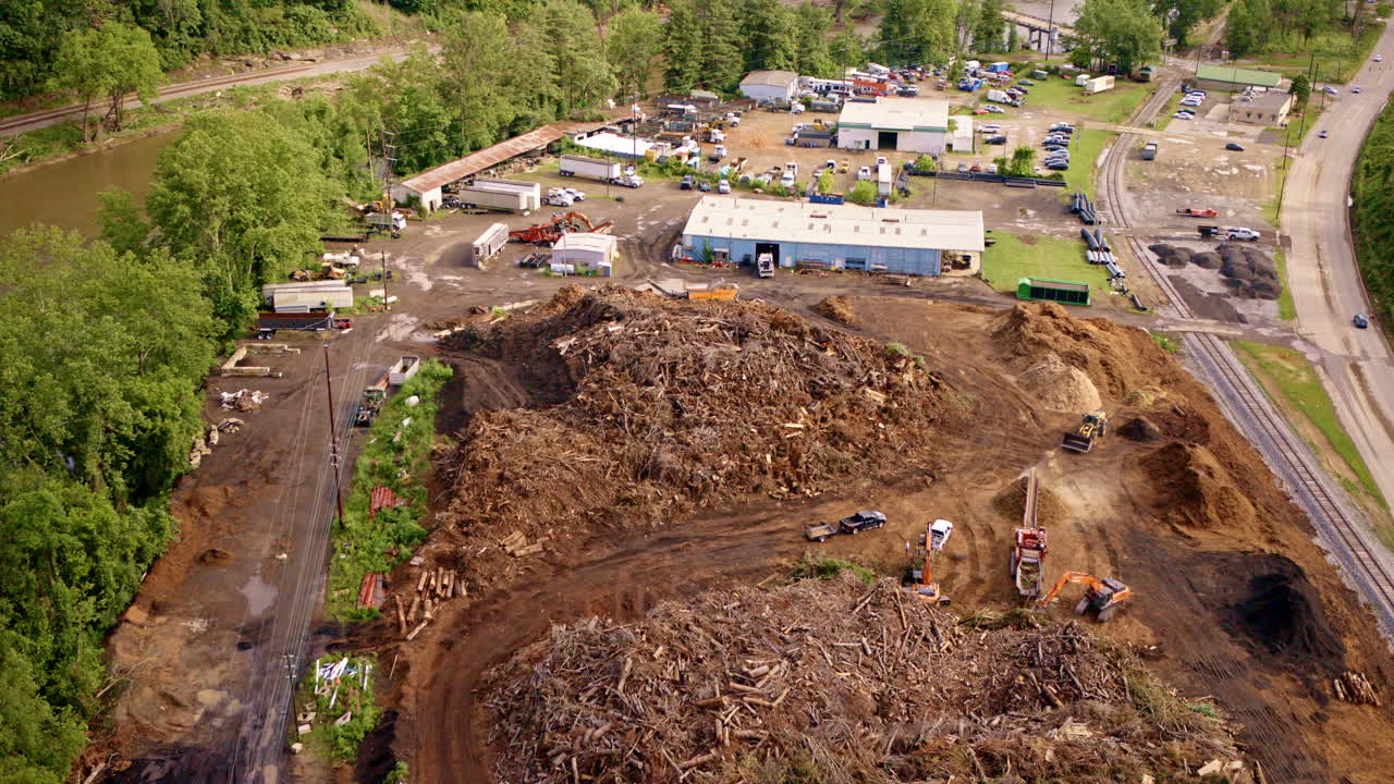 Sweeping aerial view of piles of driftwood along Asheville’s French Broad River after the flood