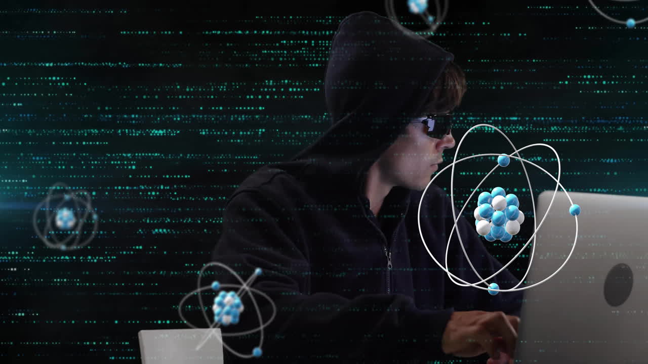 Animation of atom structures over biracial male hacker using laptop to hack system