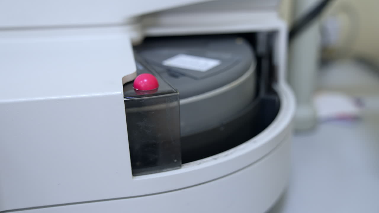 Few test tubes are moving in the apparatus. Close up. Advanced equipment in the technological science laboratory for medical tests.