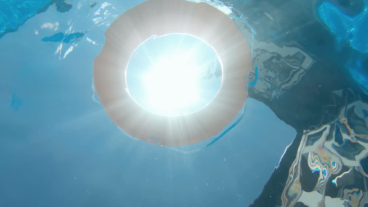 Life preserver floating in a clear pool water, slow motion, underwater view