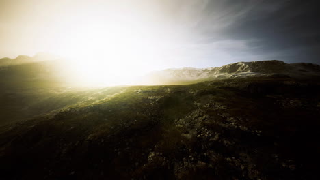 natural landscape bathed in sunlight with rocky terrain and mountains