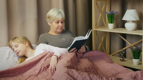 an elderly woman reads a fairy tale to a child