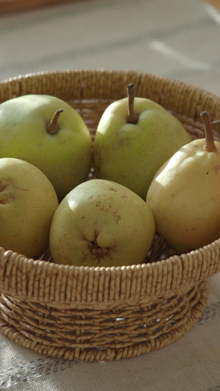 Fresh Pears in a Woven Basket with Sunlight