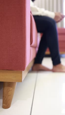 close up of woman feet on sofa at home