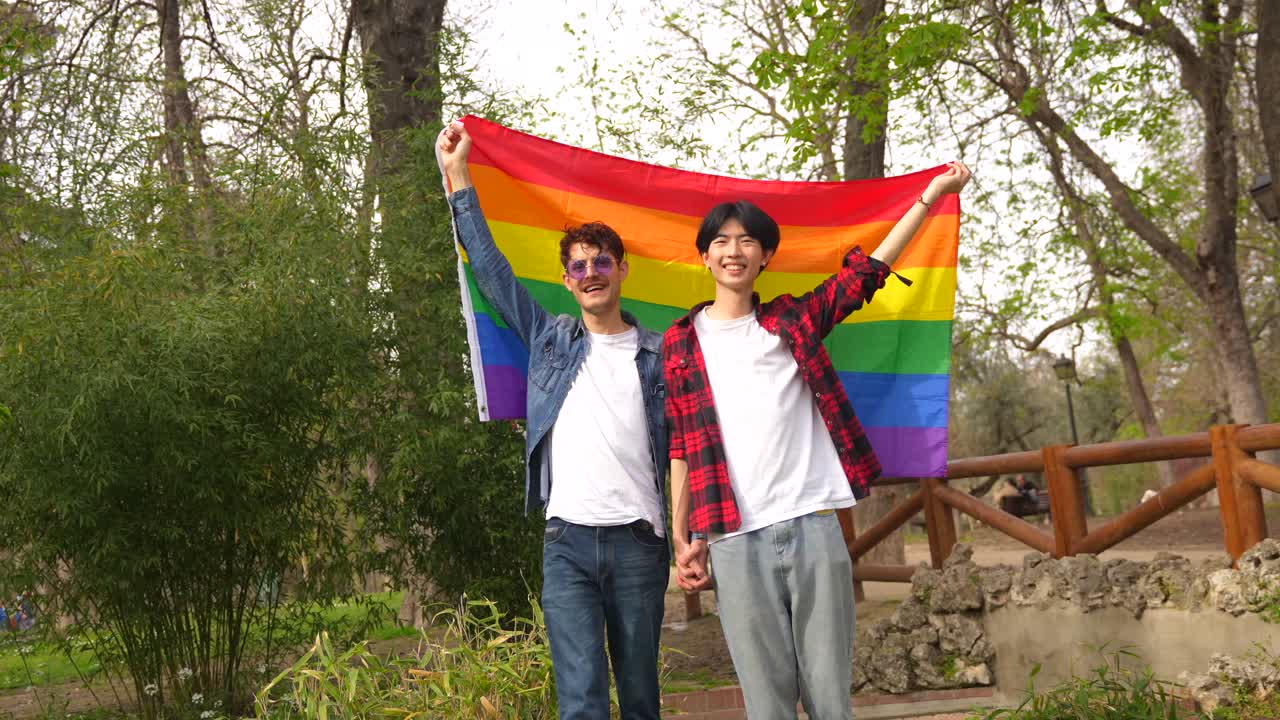 Gay Couple Celebrating Pride with Rainbow Flag