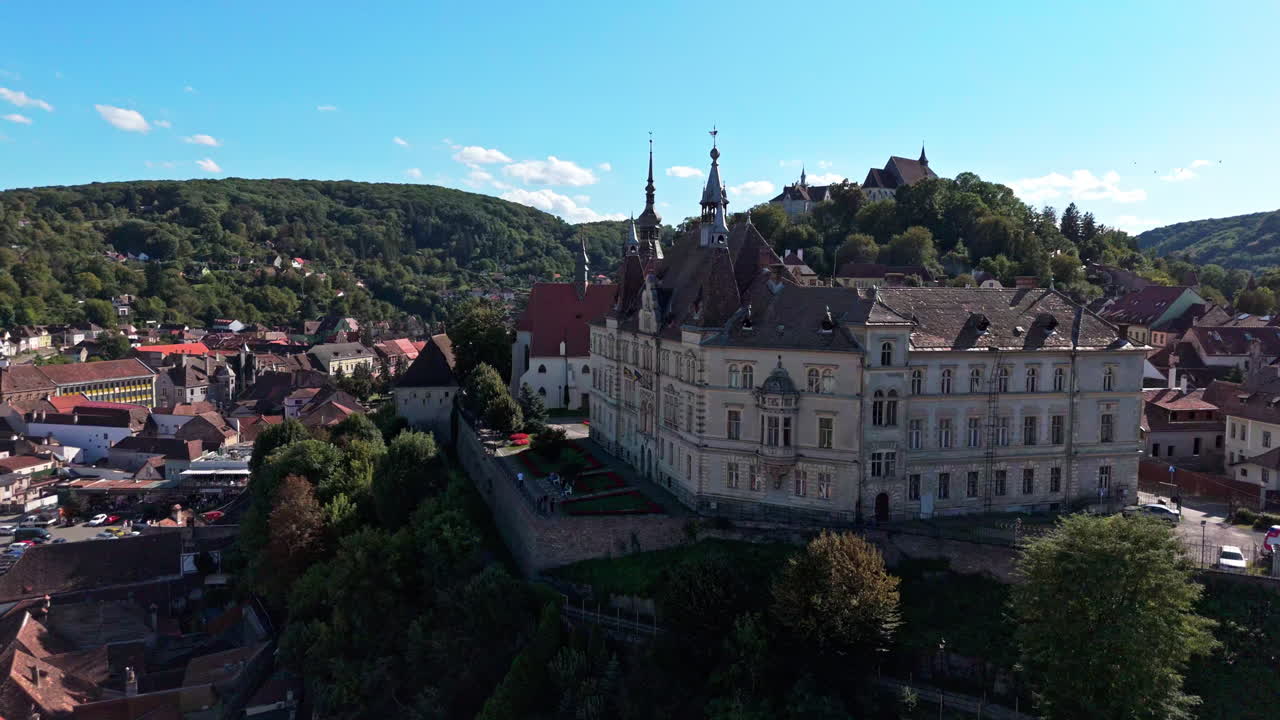 Historic Sighisoara aerial view with charming old buildings, bright day