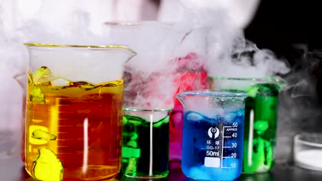 beakers with colorful liquids and dry ice reaction