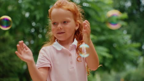 little girl playing with bubbles