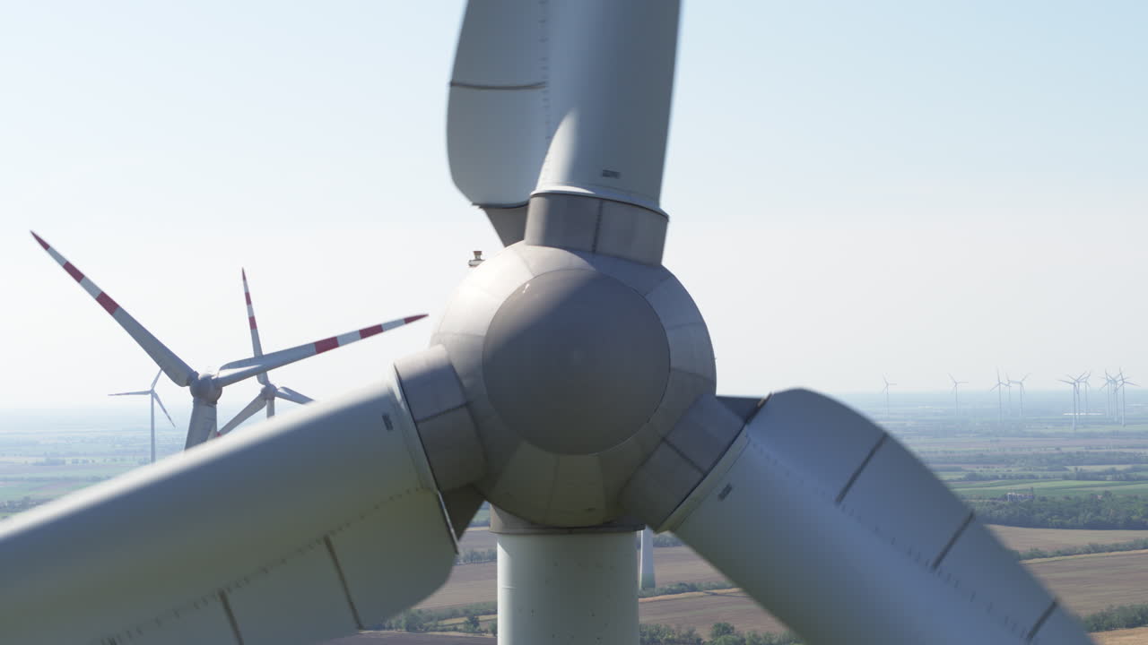 Close up wind turbine hub and main shaft along with blades
