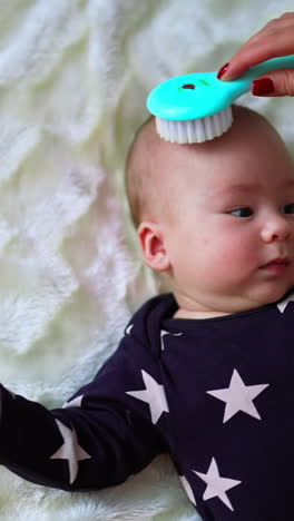 baby getting a hair brush