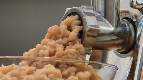 mincing meat with a meat grinder