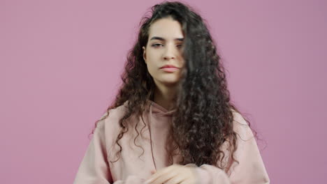 woman with curly hair expressing sadness and disappointment