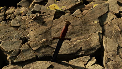 excalibur sword in rocky stone at sunset