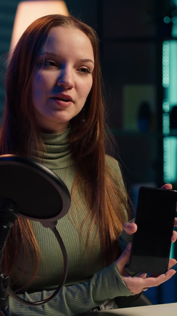 Young Woman Recording Podcast and Showing Smartphone
