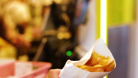 street vendor serves bubble waffles to customers