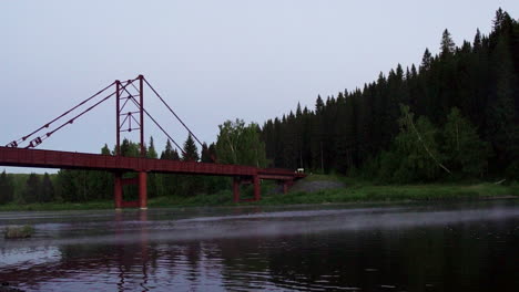 rustic bridge over river at dawn/dusk