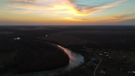 aerial view of river and fields at sunset - drone shot