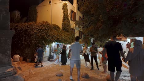 walking through kaş old town’s lively streets at night, surrounded by shops, lights, and a warm mediterranean vibe.