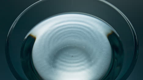 macro aqua drop flowing refreshing drink. falling blob liquid diverging circles