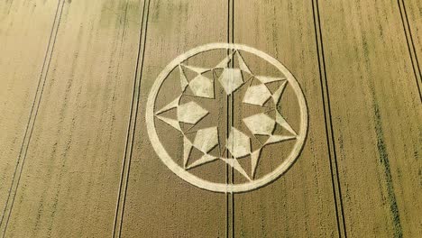 crop circle with beautiful pattern in marten, wiltshire, uk - drone shot