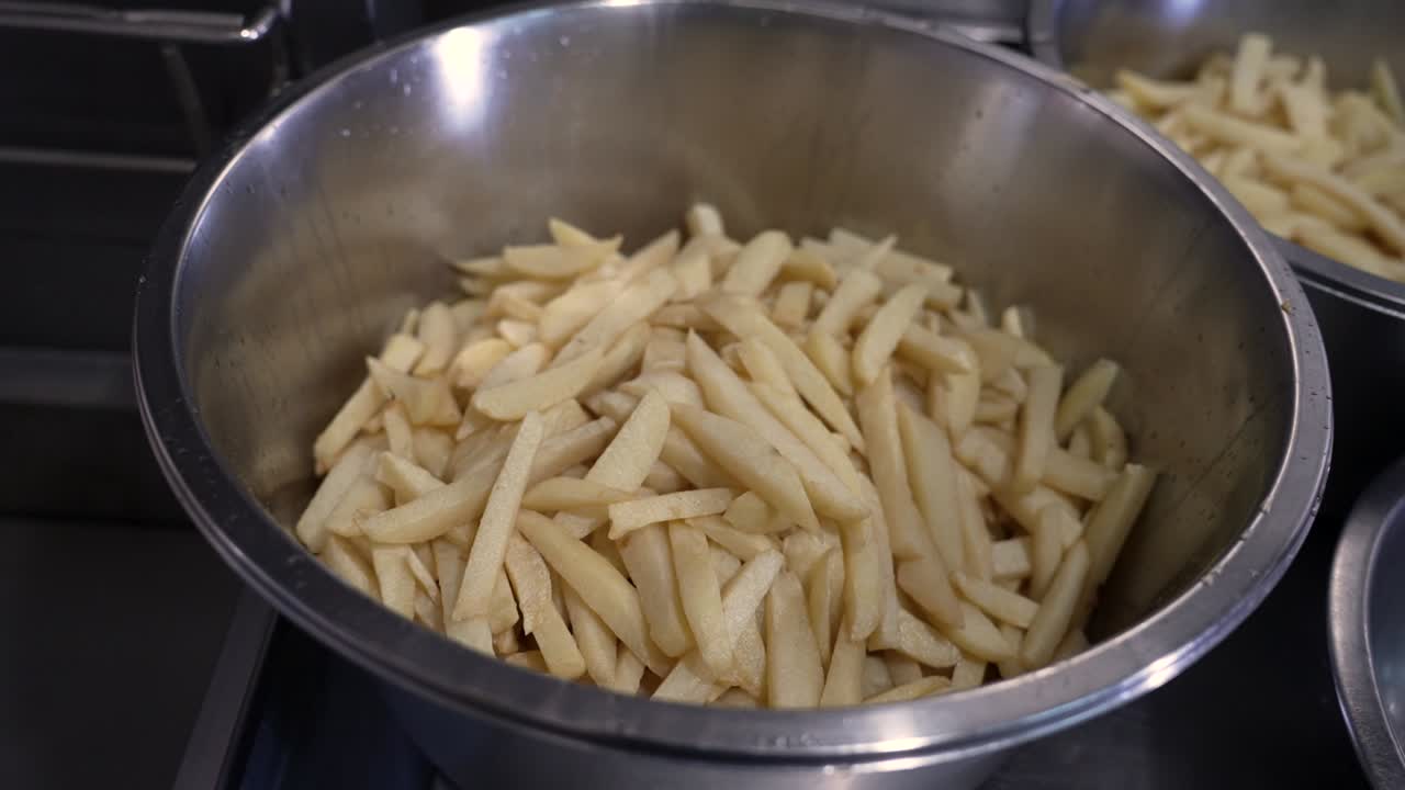 Crispy golden fries prepared fresh in bustling kitchen at local eatery during afternoon rush hour