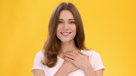 smiling woman with hands on chest