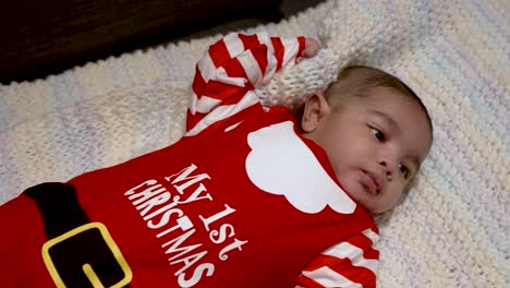 cute two month old baby boy dressed in my 1st christmas outfit laying on blanket