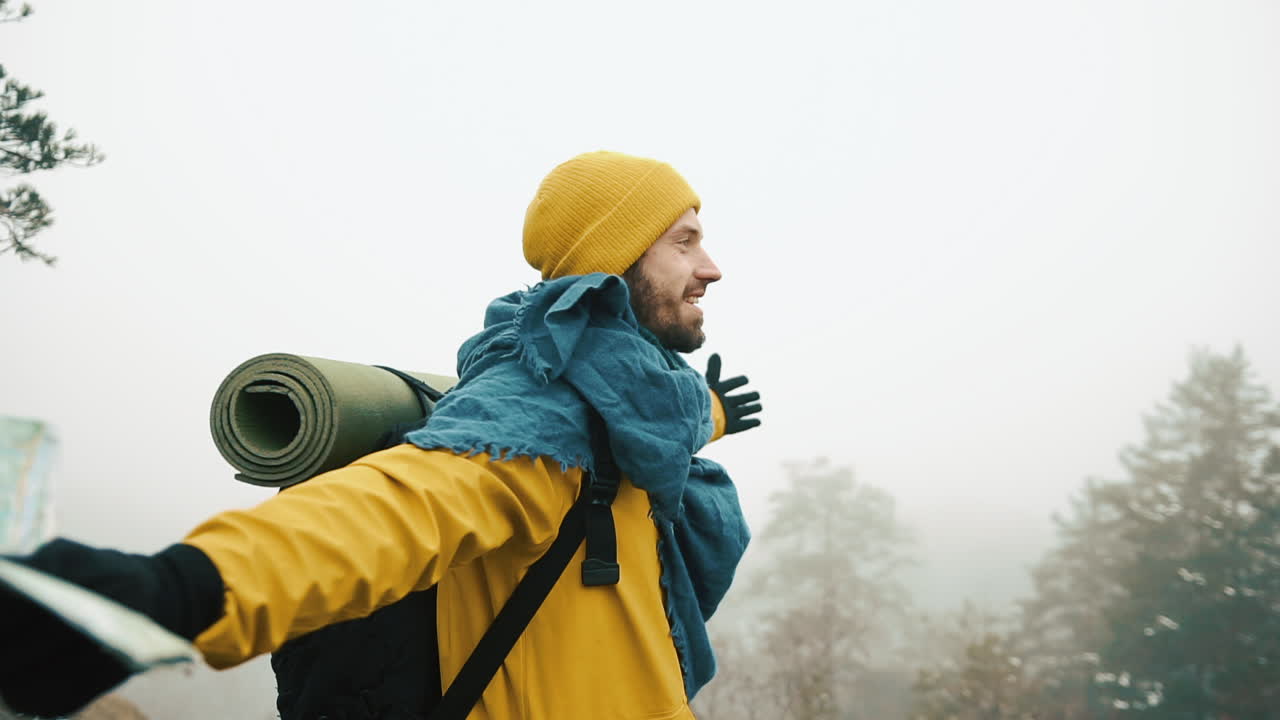 Adventurer exploring the outdoors in foggy weather
